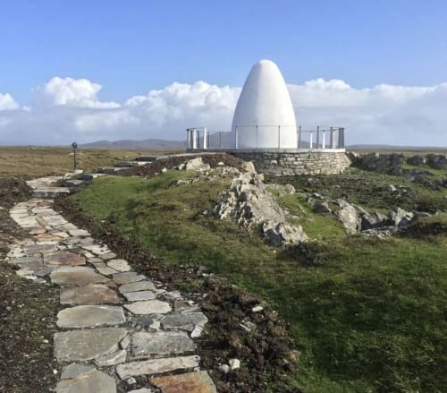 White egg-shaped sculpture on rocky hilltop with stone path, Seabrook Lodge, Clifden, Galway