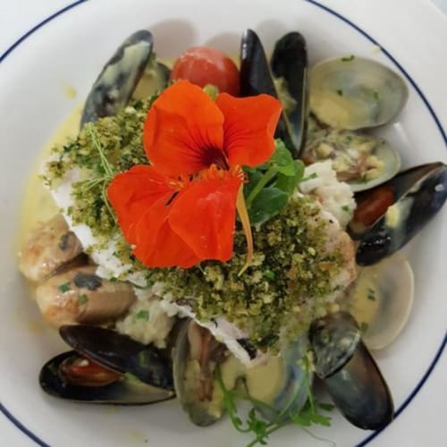 Seafood dish with mussels, clams, herb crust and edible flowers at Seabrook Lodge, Clifden