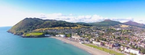 Aerial view of Bray coastal town with beach, mountains and green countryside in Ireland