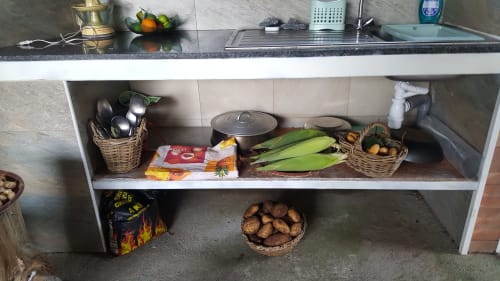 Plan de travail Case Vi D'O avec paniers de légumes, ustensiles de cuisine et produits frais à La Plaine des Cafres.