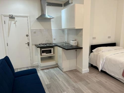 Studio room at Starlet Property London with kitchenette, bed, sofa, and compact living space