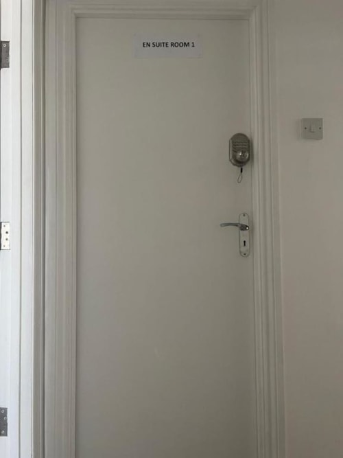 White door to En Suite Room 1 at Starlet Property London hotel with door handle and intercom