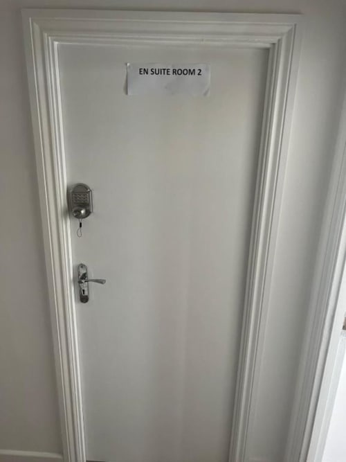 White door to En Suite Room 2 at Starlet Property hotel in London with keypad lock and handle