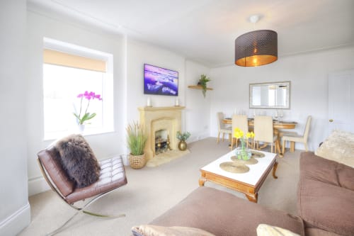 Bright modern living room at Dee-8 hotel in West Kirby with fireplace, contemporary furniture and natural light