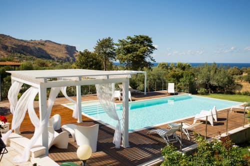Luxury villa pool terrace with turquoise swimming pool, white pergola, sea views, Sant'Andrea Valderice Sicily