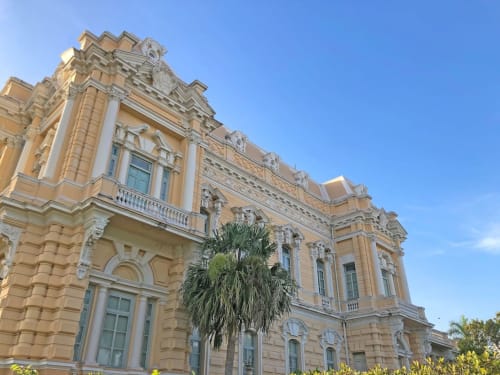 Edificio colonial amarillo histórico con detalles arquitectónicos ornamentados en Mérida, España