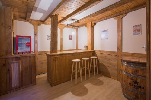 Wooden bar area with stools at Apartamentos Turísticos Ávila holiday apartments