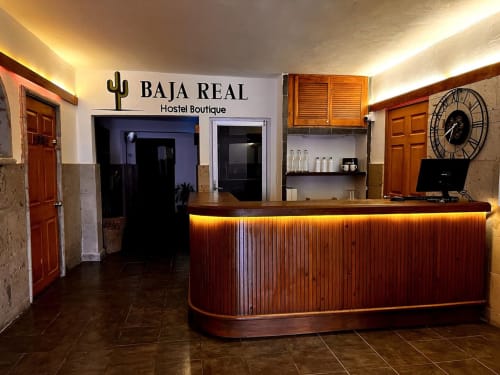 Recepción de Baja Real Hostel Boutique en La Paz con mostrador de madera e iluminación cálida