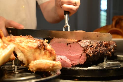 Chef carving medium-rare roast beef with Yorkshire puddings at Sliabh Beagh Hotel, Monaghan