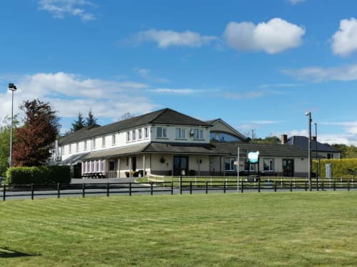 Sliabh Beagh Hotel & Tourism Centre in Monaghan, Ireland - modern white building with black roof and fencing
