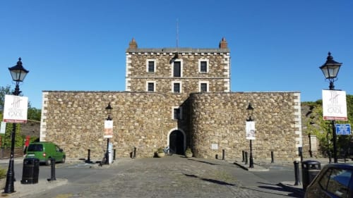 Stone fortress building with tower at Hilltop Seaview Apartment, Wicklow, Ireland under clear blue sky