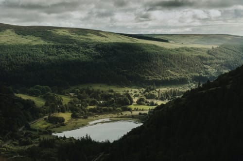Scenic valley view with lake and forested hills near Wicklow, Ireland