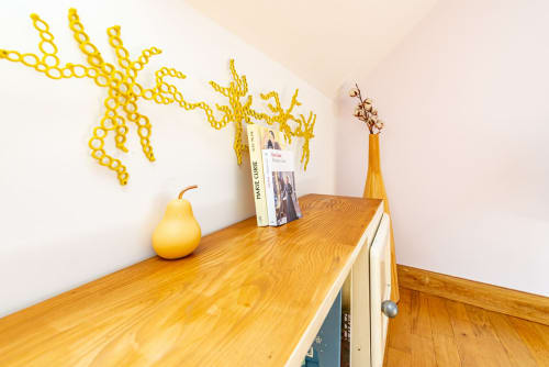 Wooden shelf with yellow pear decoration, books, and vase in Logis Marie apartment at La Maison George, Flavigny sur Ozerain