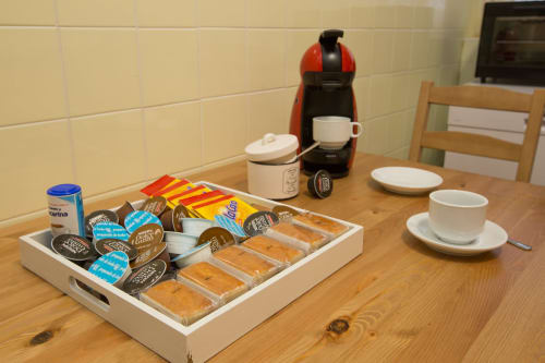 Welcome tray with coffee machine, pastries, and breakfast items in Ávila apartment