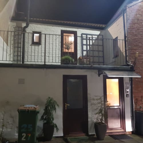 Night view of Jane's B&B apartment No 27 in Guisborough, featuring modern balcony with metal railings and illuminated
