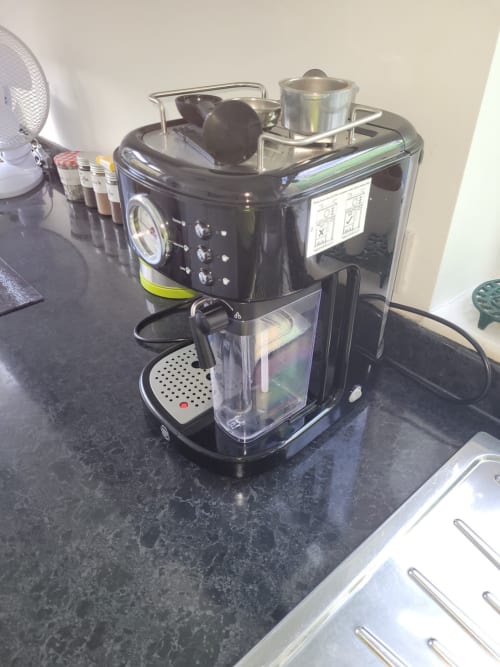 Black espresso coffee machine on kitchen counter at Jane's B&B villa in Guisborough with water pitcher and accessories