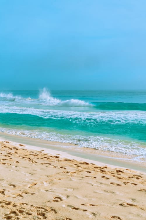 Olas turquesas y playa arenosa cerca de Cancún, costa caribeña pristina con cielo azul despejado