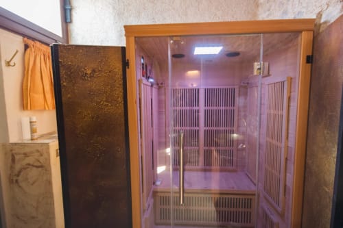 Sauna a infrarossi di CasaRosada con illuminazione viola e struttura in legno a Vidracco