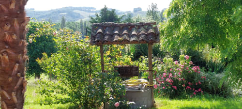 Charming garden pergola with pink roses at Les Gites de Campardon in Montbės, France, overlooking rolling countryside