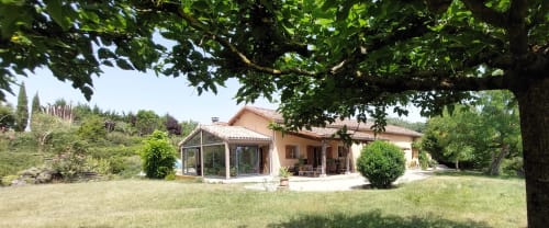 Les Gites de Campardon B&B in Monties, France with terracotta buildings, green lawn, and mature trees