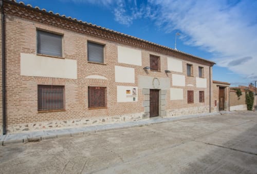 Traditional brick building with white panels, Apartamentos Turísticos Ávila, Spain