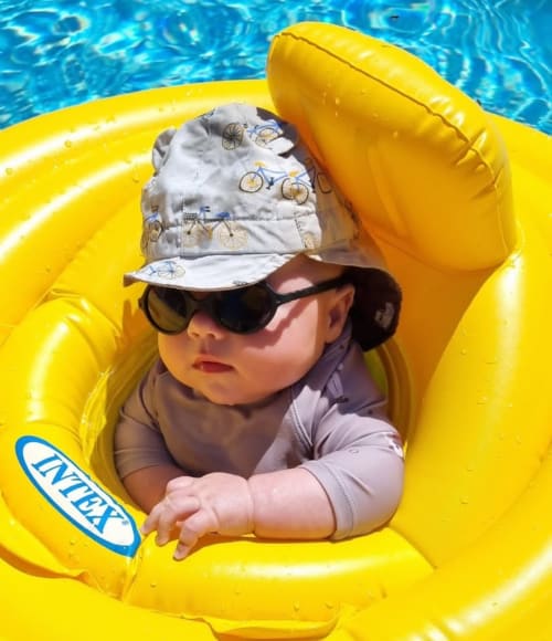 Baby in a yellow float in the pool at Domaine du Cardou