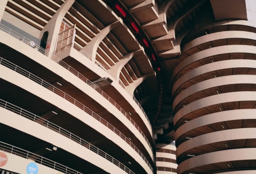 Moderno parcheggio a spirale dell'hotel Myob a Roma con livelli in cemento curvi e ringhiere in metallo