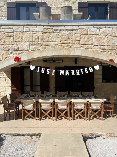 Just Married banner decorates outdoor dining area at Villa Freedom, a Crete BnB in Kokkino Chorio with stone architecture
