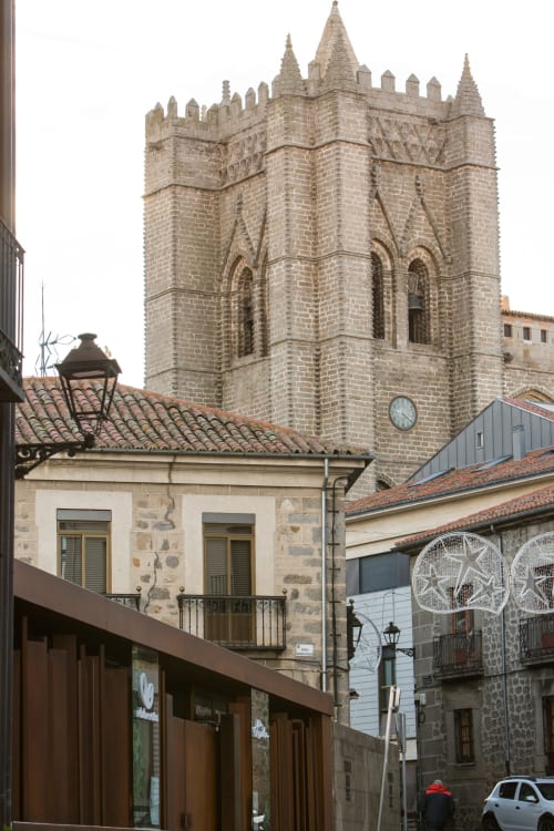 Medieval stone tower and historic buildings in Ávila's old town near Apartamentos Turísticos Ávila