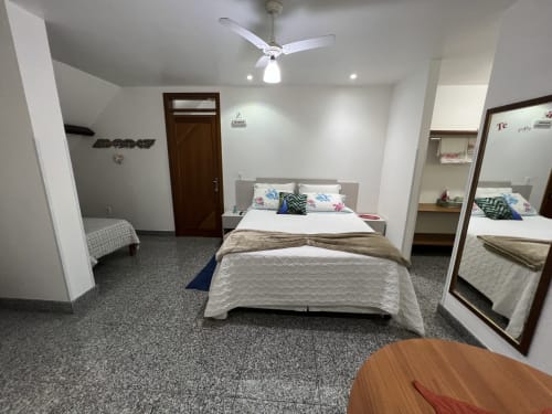 Quarto espaçoso no Pouso do Barão em Domingos Martins com cama queen, ventilador de teto e vista para o jardim
