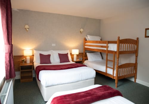 Family Room with double bed and wooden bunk beds at Sliabh Beagh Hotel, Monaghan, featuring burgundy accents and garden views