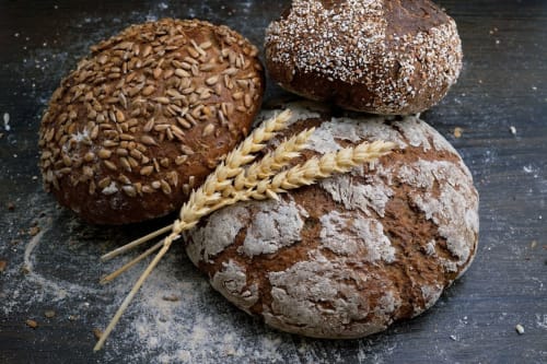 Artisan whole grain and seeded bread loaves with wheat stalks at Les Gites de Campardon, Montiers, France