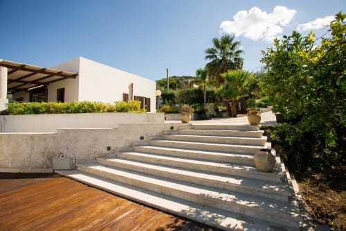 Modern villa with terrace steps, pool area, and Mediterranean gardens overlooking Sant'Andrea, Valderice