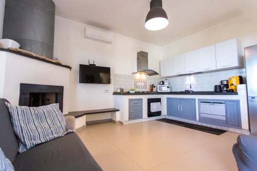 Modern kitchen and living area at Villa Maria, Sant'Andrea with fireplace, stainless steel appliances and comfortable seating