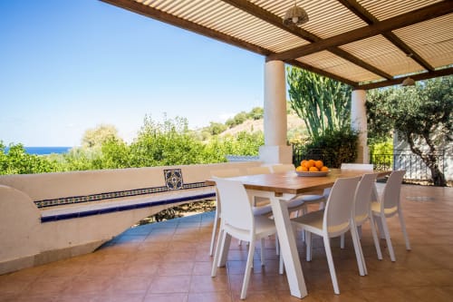 Mediterranean terrace at Villa Maria with dining table, sea views, and traditional tile details in Sant'Andrea, Valderice