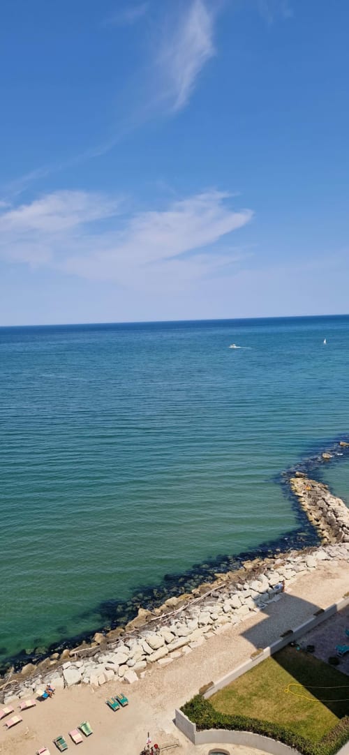 Turquoise Adriatic Sea view from Lamar Suites Seafront Apartments balcony in Misano Adriatico with sandy beach and sailboats