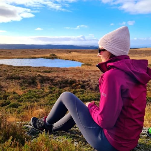 Woman overlooking scenic moorland landscape near Sliabh Beagh Hotel, Monaghan with mountain views