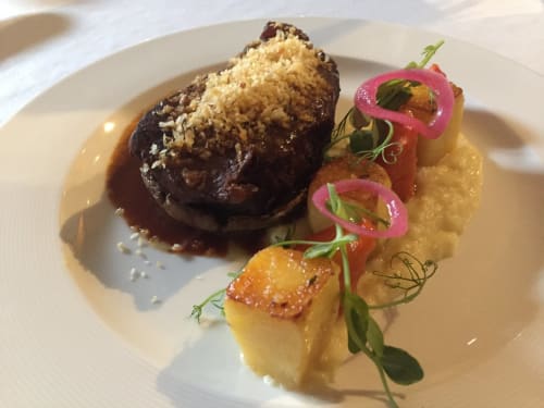 Gourmet plated dish at Sliabh Beagh Hotel featuring seared beef with crispy topping, roasted potatoes and pickled vegetables