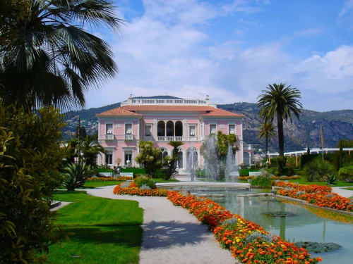 Élégante villa rose avec jardins, fontaines et fleurs orangées à l'Hôtel De La Fontaine à Nice