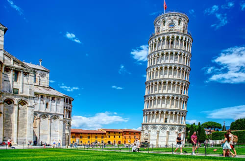 L'iconica Torre Pendente di Pisa con la cattedrale e la piazza verde, base perfetta per esplorare le attrazioni di Pisa