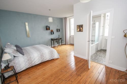 Chambre lumineuse avec mur d'accent couleur canard, parquet, lit queen-size et salle de bain attenante à La Maison D'olivier B&B