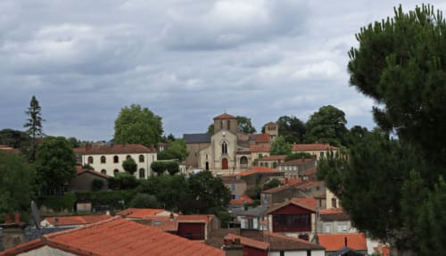 La Maison d'Olivier, gîte à Mesnard-la-Barotière, avec toits en terre cuite et architecture d'église médiévale