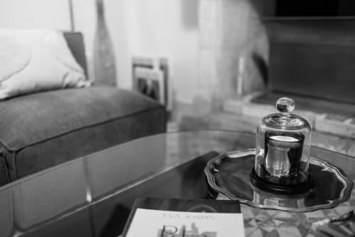 Elegant candle holder on table at Le Prieuré Notre-Dame boutique hotel in Montfrin, France, with sofa blurred in background