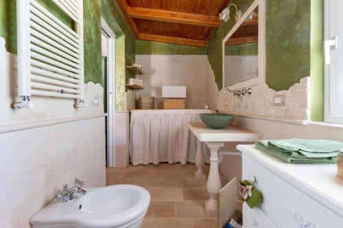 Ampio bagno a Villa Margherita con pareti verdi, travi in legno, lavabo su piedistallo e toilette a Santeramo in Colle