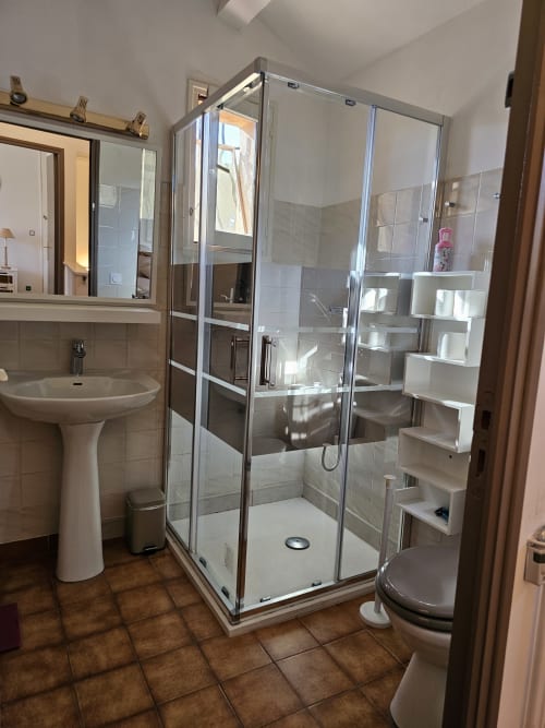 Modern bathroom with glass shower enclosure at Villa Sigahi B&B in La Croix Valmer, France