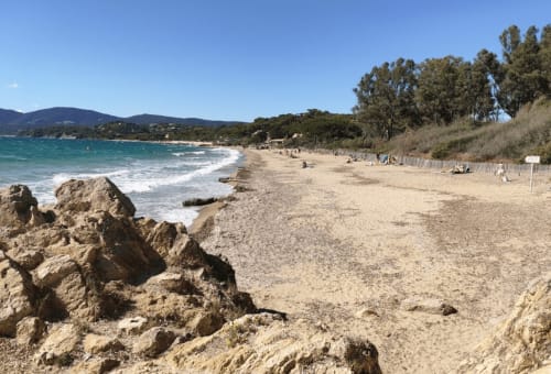 Sandy beach with turquoise waters and rocky coastline near Villa Sigahi in La Croix Valmer, France