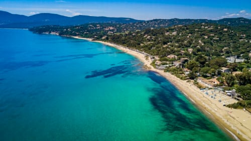 Aerial view of Villa Sigahi's turquoise coastline in La Croix Valmer with sandy beach and Mediterranean villas