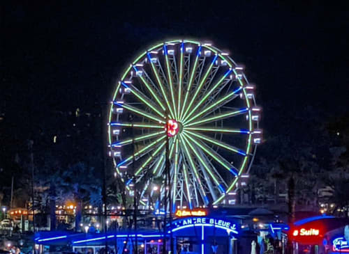 Illuminated ferris wheel at night in La Croix Valmer, France near Villa Sigahi