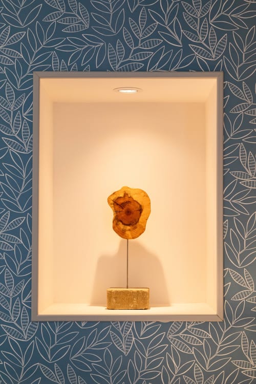 Wooden tree sculpture in illuminated niche at Clos des Moulins boutique hotel, Poitiers