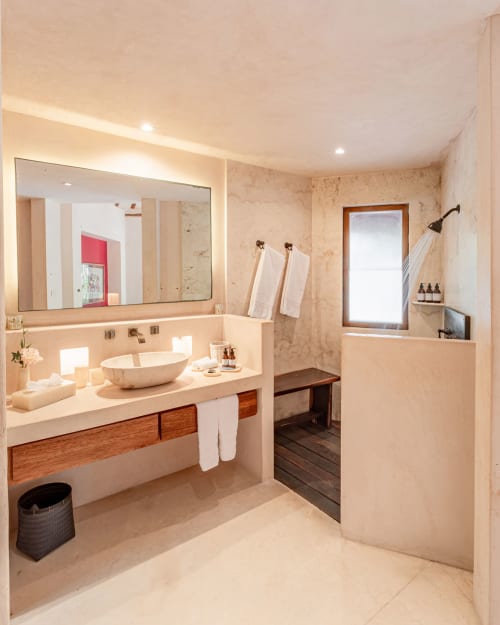 Luxury bathroom with vessel sink, illuminated mirror, and spa-style shower at Cantarena House villa in Tulum